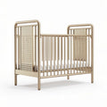 Metal crib with breathable mesh sides and mattress support for infants